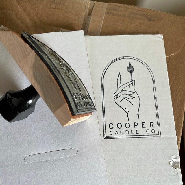 picture of a wood rocker rubber stamp and white cardboard box with black ink impression